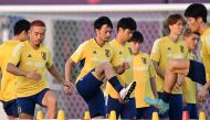 Japan's defender Yuto Nagatomo (left) and Japan's midfielder Gaku Shibasaki (centre) take part in a training session at the Al Sadd SC training grounds in Doha on December 3, 2022, during the Qatar 2022 World Cup football tournament. (Photo by INA FASSBENDER / AFP)