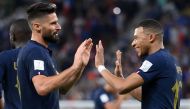 France's forward Kylian Mbappe (right) celebrates scoring his team's second goal with Olivier Giroud during the Qatar 2022 World Cup round of 16 football match between France and Poland at the Al-Thumama Stadium in Doha on December 4, 2022. (Photo by FRANCK FIFE / AFP)