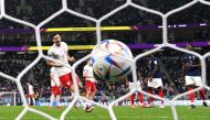 Poland's Robert Lewandowski scores his team's first goal after the penalty had to be retaken during the Qatar 2022 World Cup round of 16 football match between France and Poland at the Al Thumama Stadium in Doha on December 4, 2022. (AFP / Kirill Kudryavtsev)