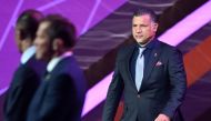 In this file photo taken on April 1, 2022, former Iranian footballer Ali Daei (right) arrives on stage during the draw for the 2022 World Cup in Qatar at the Doha Exhibition and Convention Center.(Photo by GABRIEL BOUYS / AFP)