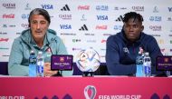 Switzerland's coach Murat Yakin (L) and Switzerland's forward #07 Breel Embolo (R) attend a press conference in Doha on December 5, 2022, on the eve of the Qatar 2022 World Cup Round of 16 football match between Portugal and Switzerland. (Photo by Fabrice COFFRINI / AFP)