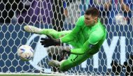 Croatia's Dominik Livakovic saves a penalty missed by Japan's Takumi Minamino during the FIFA World Cup Qatar 2022 Round of 16 match at the Al Janoub Stadium, Al Wakrah, Qatar, on December 5, 2022.  REUTERS/Marko Djurica