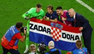 Croatia's Dominik Livakovic celebrates with Luka Modric after winning the penalty shootout as Croatia progress to the quarter finals of the FIFA World Cup Qatar 2022 at the Al Janoub Stadium, Al Wakrah, Qatar, on December 5, 2022.  REUTERS/Lee Smith