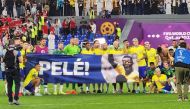 Brazil players pose for photo behind a large banner of Pele after their FIFA World Cup Qatar 2022 Round of 16 win over South Korea at the Stadium 974 in Doha on December 5, 2022.  Photo: Abdul Basit / The Peninsula