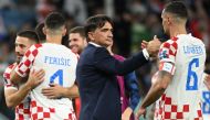 Croatia's coach #00 Zlatko Dalic (C) congratulates Croatia's defender #06 Dejan Lovren for their win in the Qatar 2022 World Cup round of 16 football match between Japan and Croatia at the Al-Janoub Stadium in Al-Wakrah, south of Doha on December 5, 2022. (Photo by Ina Fassbender / AFP)