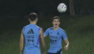 Argentina's forward Julian Alvarez (R) eyes the ball next to Argentina's defender Lisandro Martinez during a training session at Qatar University in Doha, on December 5, 2022 ahead of the Qatar 2022 World Cup quarterfinal football match against Netherlands to be held on December 9 at Lusail stadium. (Photo by JUAN MABROMATA / AFP)