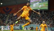 Netherlands' Denzel Dumfries celebrates scoring their third goal against the United States during the Qatar 2022 World Cup round of 16 football match between the Netherlands and USA at Khalifa International Stadium in Doha on December 3, 2022. (REUTERS/John Sibley)