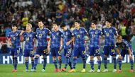 Japan's players stand together at the start of the penalty shootout during the Qatar 2022 World Cup round of 16 football match between Japan and Croatia at the Al-Janoub Stadium in Al-Wakrah, south of Doha on December 5, 2022. (Photo by Ina Fassbender / AFP)