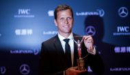 This file photo taken on April 15, 2015 shows Oliver Bierhoff, manager of the German national football team, posing with the Laureus World Sports Team of the Year Award during the Laureus World Sports Award ceremony at the Grand Theater in Shanghai.  (Photo by JOHANNES EISELE / AFP)