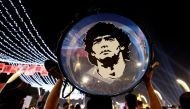 An Argentina fan holds up his drum showing an image of former player Diego Maradona on the Doha Corniche in Doha, Qatar, on November 25, 2022.  File Photo/Reuters