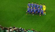 Japan players pose for a team group photo. Reuters