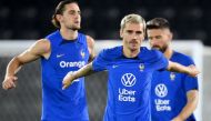 France's midfielder Adrien Rabiot, France's forward Antoine Griezmann and France's forward Olivier Giroud attend a training session at the Jassim-bin-Hamad Stadium in Doha on December 6, 2022, during the Qatar 2022 World Cup football tournament. (Photo by FRANCK FIFE / AFP)