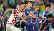 Croatia's Dejan Lovren celebrate qualifying for the quarter finals, as Japan players look dejected after being eliminated from the FIFA World Cup Qatar 2022, at the Al Janoub Stadium, Al Wakrah, Qatar, on December 5, 2022.  REUTERS/Marko Djurica
 
