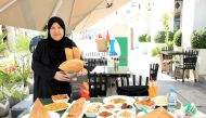 Chef Shams Al Qassabi with her specialities outside her restaurant at Souq Waqif. Pics: Salim Matramkot / The Peninsula