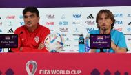 Croatia's coach Zlatko Dalic (left) and midfielder Luka Modric hold a press conference at the Qatar National Convention Center (QNCC) in Doha on December 8, 2022, on the eve of the Qatar 2022 World Cup quarter final football match between Brazil and Croatia. (Photo by JACK GUEZ / AFP)