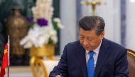 This handout picture provided by the Saudi Royal Palace shows Chinese President Xi Jinping signing an agreement with the Custodian of the Two Holy Mosques, King Salman bin Abdulaziz Al-Saud of the Kingdom of Saudi Arabia (not pictured), in the capital Riyadh, on December 8, 2022. (Photo by BANDAR AL-JALOUD / AFP) 