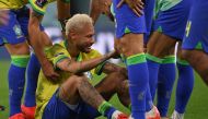 Brazil's Neymar is consoled by teammates after they lost the Qatar 2022 World Cup quarter-final match against Croatia at Education City Stadium on December 9, 2022. (Photo by NELSON ALMEIDA / AFP)