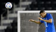 France’s forward Kylian Mbappe heads the ball during a training session. AFP