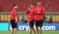 (From left) Morocco's midfielder #13 Ilias Chair, Morocco's forward #10 Anass Zaroury and Morocco's defender #06 Romain Ghanem Saiss inspect the pitch ahead of the Qatar 2022 World Cup quarter-final football match between Morocco and Portugal at the Al-Thumama Stadium in Doha on December 10, 2022. (Photo by KARIM JAAFAR / AFP)