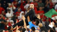 Morocco coach Walid Regragui celebrates with the players after the match as Morocco progress to the semi finals of the FIFA World Cup Qatar 2022 at the Al Thumama Stadium in Doha on December 10, 2022.  REUTERS/Bernadett Szabo 