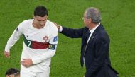 Portugal's coach Fernando Santos pats Portugal's forward Cristiano Ronaldo on his back as he leaves the field after losing to Morocco 1-0 in the Qatar 2022 World Cup quarter-final football match between Morocco and Portugal at the Al-Thumama Stadium in Doha on December 10, 2022. (Photo by JUAN MABROMATA / AFP)