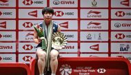 Japan's Akane Yamaguchi holds the winner's trophy after her victory against Taiwan's Tai Tzu-ying in Bangkok on December 11, 2022. (Photo by Lillian Suwanrumpha / AFP)