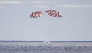 NASA's unmanned Orion spaceship splashes down in the Pacific Ocean off Baja California, Mexico, on December 11, 2022. - Orion was launched November 16 on the Artemis rocket for a 25-day mission to the Moon. The main goal of this mission was to test Orion's heat shield -- for the day when it is humans and not test mannequins riding inside. (Photo by CAROLINE BREHMAN / POOL / AFP)