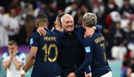 France’s coach Didier Deschamps (centre) celebrates with Kylian Mbappe and Antoine Griezmann after win over England. AFP