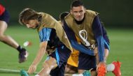 Croatia's midfielder Luka Modric and Croatia's defender Dejan Lovren take part in a training session at the Al Erssal Training Site 3 in Doha on December 12, 2022, on the eve of the Qatar 2022 World Cup semi final football match between Argentina and Croatia. (Photo by JACK GUEZ / AFP)