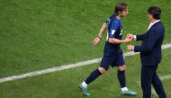 Croatia’s midfielder Luka Modric is greeted by coach Zlatko Dalic as he leaves the pitch. AFP