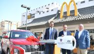 Officials of McDonald’s Qatar hand over the prize to a winner of the  ‘Scan & Win’ campaign.