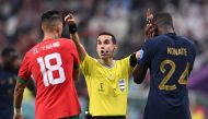 Mexican referee Cesar Ramos waves away Morocco's defender Jawad El Yamiq and France's defender Ibrahima Konate during the Qatar 2022 World Cup semi-final match between France and Morocco at the Al-Bayt Stadium on December 14, 2022. (Photo by Kirill Kudryavtsev / AFP)