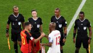 Fourth official Yoshimi Yamashita (second left) looks on with other officials as Belgium’s Eden Hazard shakes hands with Canada’s Atiba Hutchinson before the start of their World Cup Group F match at Ahmad Bin Ali Stadium. REUTERS