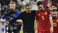 In this file photo taken on November 27, 2022 Spain's midfielder Sergio Busquets listens to Spain's coach Luis Enrique after the Qatar 2022 World Cup Group E football match between Spain and Germany at the Al-Bayt Stadium. (Photo by Javier Soriano / AFP)