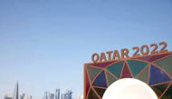 Qatar 2022 logo in front of the skyline of the West Bay in Doha.