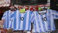 View of t-shirts of the Argentine national football team at a store in the eve of the Qatar 2022 World Cup final match between Argentina and France in Buenos Aires, on December 16, 2022. (Photo by Luis ROBAYO / AFP)