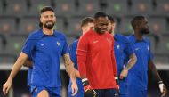 France's forward Olivier Giroud (left) and France's goalkeeper Steve Mandanda take part in a training session at the Al Sadd SC training centre in Doha on December 17, 2022, on the eve of the Qatar 2022 World Cup football final match between Argentina and France. (Photo by FRANCK FIFE / AFP)