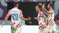 Croatia's midfielder #10 Luka Modric (second left) and his teammates celebrate scoring their team's second goal during the Qatar 2022 World Cup third place play-off football match between Croatia and Morocco at Khalifa International Stadium in Doha on December 17, 2022. (Photo by JACK GUEZ / AFP)