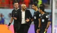 Morocco coach Walid Regragui talks to referee Abdulrahman Al Jassim after the FIFA World Cup Qatar 2022 third-place match against Croatia at the Khalifa International Stadium in Doha on December 17, 2022. REUTERS/Paul Childs