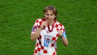 Croatia's Luka Modric bites his medal as he celebrates Croatia finishing in third place at the end of the FIFA World Cup Qatar 2022 third-place playoff against Morocco at the Khalifa International Stadium, Doha, Qatar, on December 17, 2022.   REUTERS/Kai Pfaffenbach
