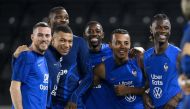 France's midfielder Jordan Veretout, France's forward Kylian Mbappe, France's forward Marcus Thuram, France's forward Ousmane Dembele, France's defender Jules Kounde and France's midfielder Eduardo Camavinga attend a training session at the Al Sadd SC training centre in Doha on December 16, 2022, during the Qatar 2022 World Cup football tournament. (Photo by FRANCK FIFE / AFP)