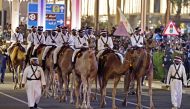 Qatar mounted camel police escort Argentina players on a bus outside the Lusail Stadium after winning the World Cup on December 18, 2022.  REUTERS/Hamad I Mohammed