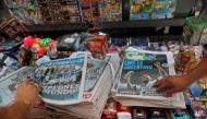 A picture of newspapers at a newstand with images of Argentina's Lionel Messi celebrating with the trophy after winning the FIFA World Cup Qatar 2022 in the front page, in Buenos Aires, Argentina on December 19, 2022. REUTERS/Agustin Marcarian