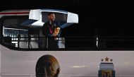 Argentina's captain and forward Lionel Messi holds the FIFA World Cup Trophy on board a bus upon arrival at Ezeiza International Airport on December 20, 2022. (Photo by Luis Robayo / AFP)