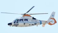 Argentina's Paulo Dybala and Nahuel Molina are seen inside a helicopter after celebrating on board a bus with a sign reading 