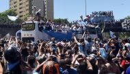 Argentina fans celebrate as the the bus carrying the players and the World Cup trophy is seen during the victory parade in Buenos Aires on December 20, 2022.  REUTERS/Martin Villar