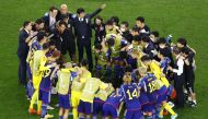 Japan coach Hajime Moriyasu, coaching staff and players in a huddle before the penalty shootout against Croatia, in this December 5 file photo. REUTERS