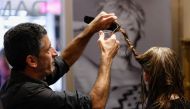 Belgian hairdresser at hair salon L'Atelier Chedly Boussigua cuts a customer's hair, which will be collected by the association Dung Dung, in Brussels, Belgium November 4, 2022. Reuters/Yves Herman