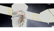 A stream of particles, which NASA says appears to be liquid and possibly coolant, sprays out of the Soyuz spacecraft on the International Space Station, forcing a delay of a routine planned spacewalk by two Russian cosmonauts December 14, 2022 in this still image taken from video. (NASA TV/Handout via REUTERS)