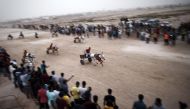 File Photo: Bahraini men ride their donkey carts as they compete in a local race in the village of Saar, West of the capital Manama, on September 4, 2015. (AFP/Getty Images)

